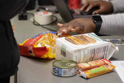 Students check out food from the Shocker Support Locker. The locker offers free products to students, faculty and staff Monday through Friday.