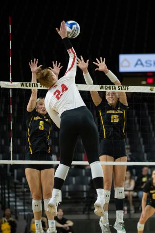 Morgan Stout and Kayce Litzau block a spiked ball on Nov. 13 in Charles Koch Arena. The Shockers fell to Houston in three sets.