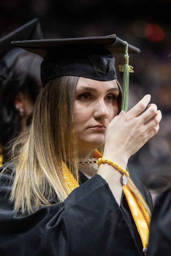 A graduate flips their tassle to the other side during the Fall Commencement ceremony on Dec. 18 inside Charles Koch Arena.