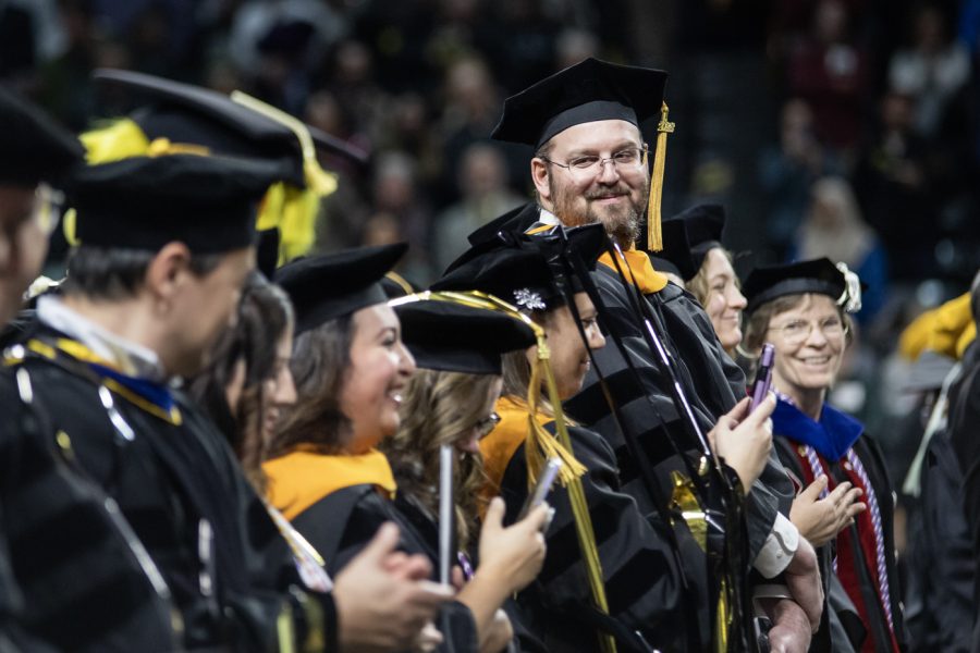 Graduates laugh together during the Fall 2022 Commencement ceremony on Dec. 18.