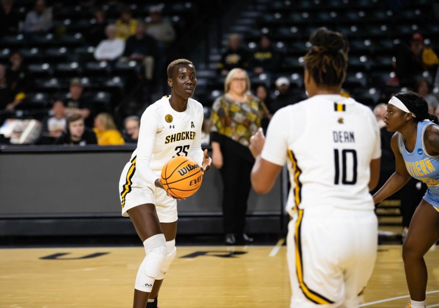 Senior forward Jane Asinde gets ready to pass the ball to senior guard Curtessia Dean. Asinde had 15 points, 12 rebounds, one assist, one block and one steal. 