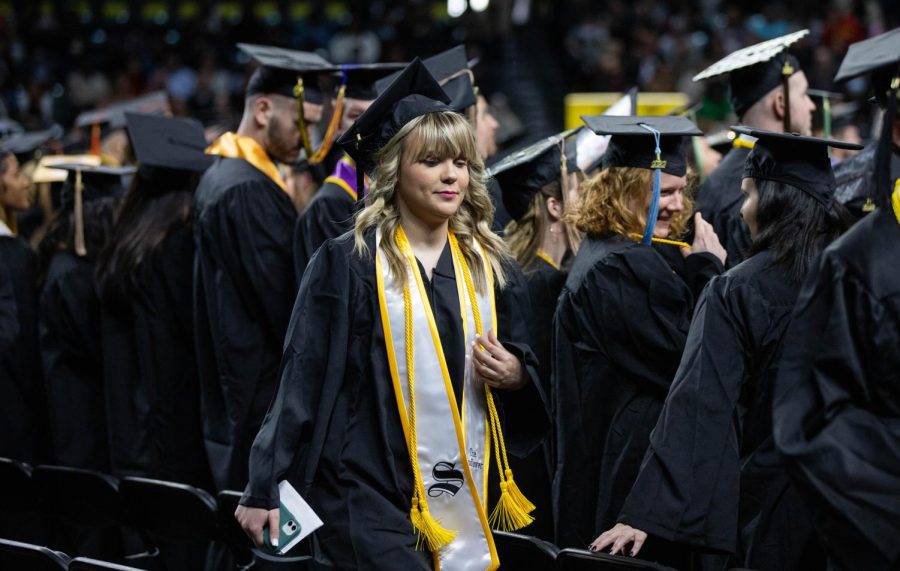 Lindsay Smith walks to her seat during Fall 2022 Commencement on Dec. 18.