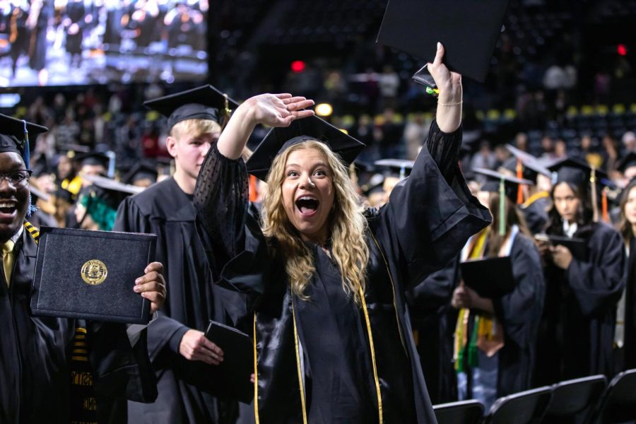 Fall 2022 graduate Mackenzie Lane celebrates after recieving her diploma.