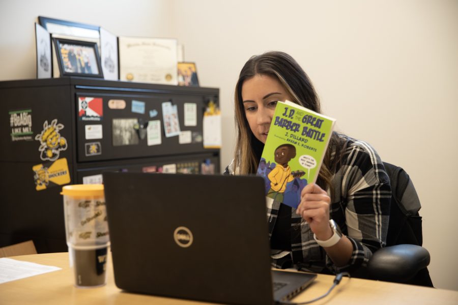 Kayla+Jasso%2C+director+of+communications+for+undergraduate+admissions%2C+reads+to+Gordon+Parks+Elementary+student+during+a+WUreads+session.+Volunteers+read+every+Friday+for+20+minutes.