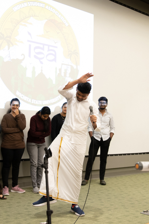 A student raises his hand and brings it down to his knee, sending cheers throughout the audience. His clothes are a traditional Indian outfit, according to Perlekar Tamtam, the faculty advisor for the Indian Student Association.