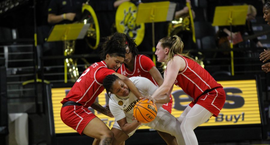 Senior guard Curtessia Dean tries to steal the ball from two of Southern Methodist players on Jan. 18. Dean scored 16 points against SMU in the Shockers 73-65 win.