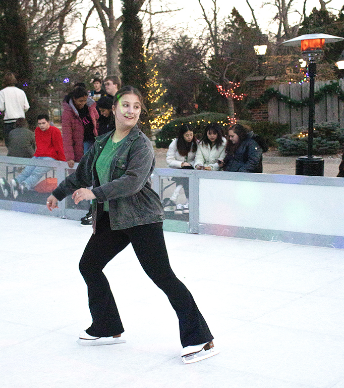 Sophomore Madelyn Stilwell grins after successfully completing a spin on the ice. Stilwell has been figure skating for 11 years and enjoys practice at the local Wichita skating rink. 