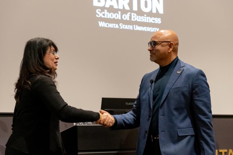 Tanvir Arfi shakes hands with the Business School Dean Larisa Genin. Arfi provided a lecture about cars on Feb 16.