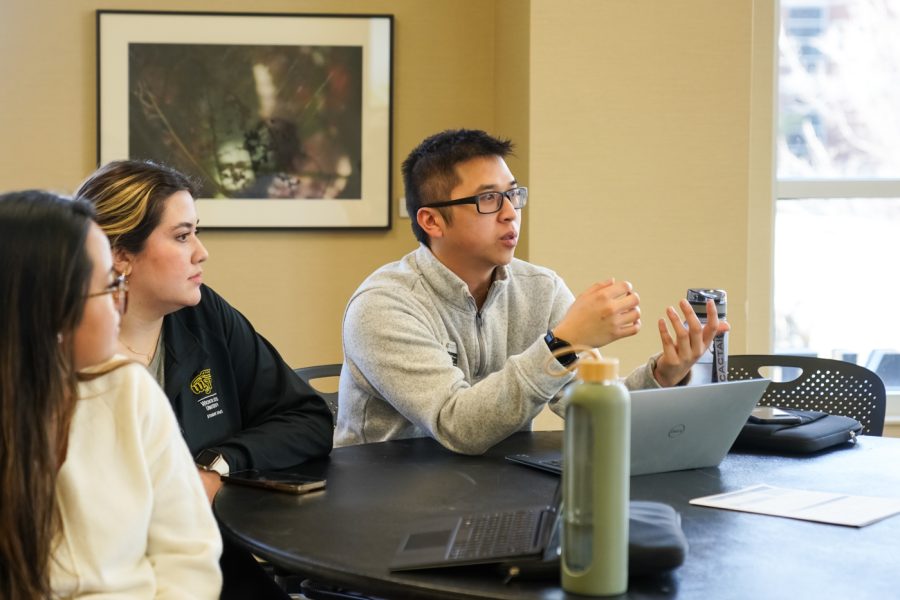 Quang Nguyen, assistant director of the Office of Diversity and Inclusion, speaks to Tajahnae Stocker during the College Hunger Tour in the RSC on Feb. 14.