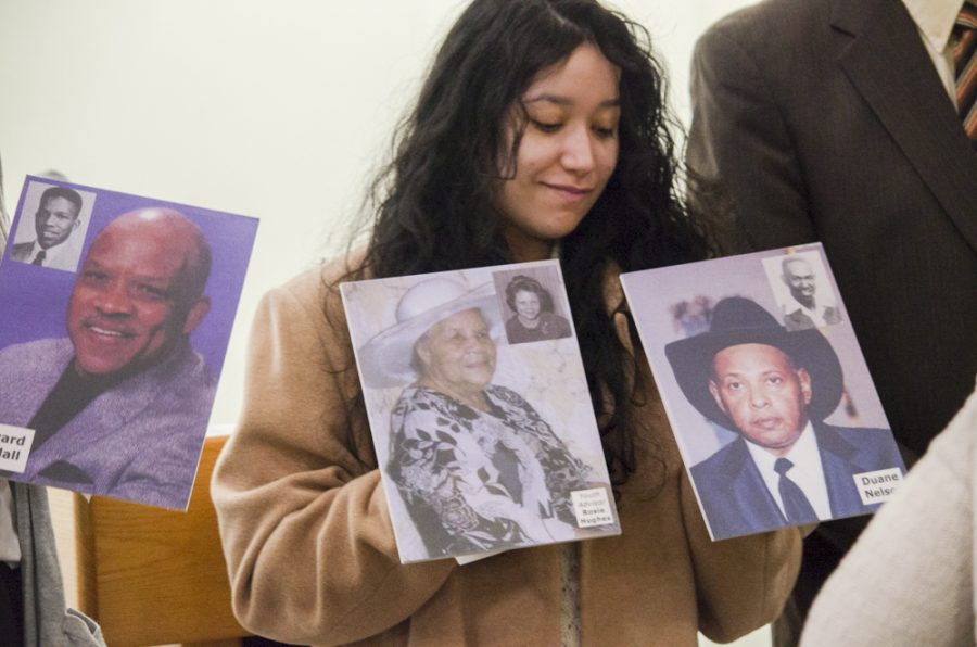 Valeria Paunetto, a peer mentor and student assistant with the Office of Diversity and Inclusion, poses with portraits of members from the Dockum Sit-In Protesters. On Jan 31, the Office of Diversity and Inclusion commemorated Dr. Galyn Vesey and his work with the Dockum Sit-In Protesters.