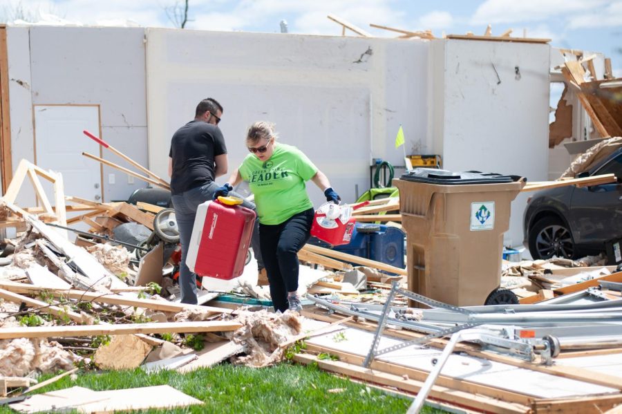 Andover neighborhood residents clean up much of the debris created by the tornado that swept through the town and surrounding areas the previous night.