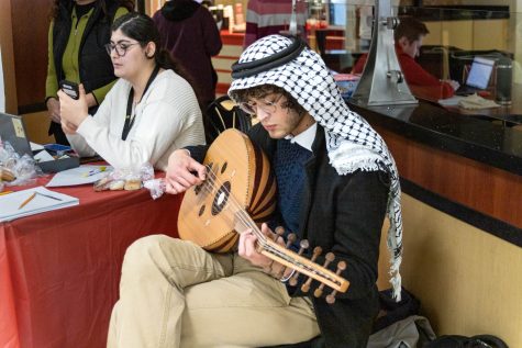 Abdelkarim Jibril helps table the Arab Fundraiser held in the RSC on March 2. Jibril played various songs on his oud.