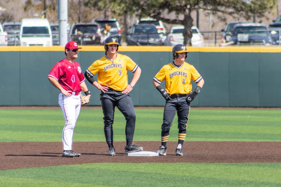 Following a confusing play, Chuck Ingram (#9) stands on second base with Brock Rodden (#8). Referees determined an infield fly was made by #29 Garrett Pennington. Ingram stayed on second, Rodden returned to first, and Pennington was forced out.