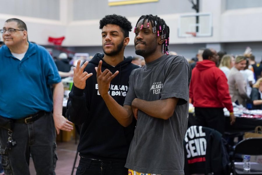 DAydrian Harding poses with a an attendee during the Kansas Sneaker Fest. Harding, a creator on TikTok, hosted the event at Charles Koch Arena.