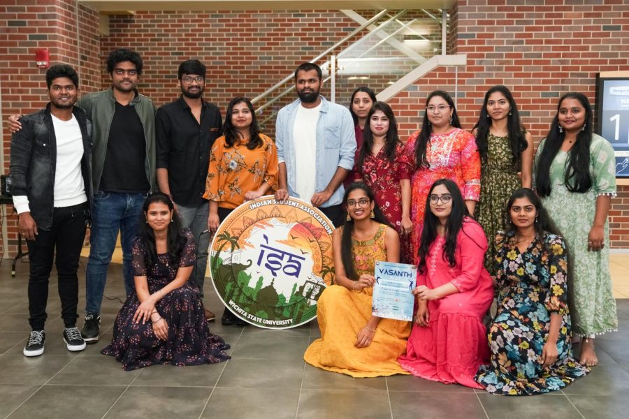 Indian Student Association poses for a picture with the poster of VASANTH the event wichita is gonna happen on Apr. 7.