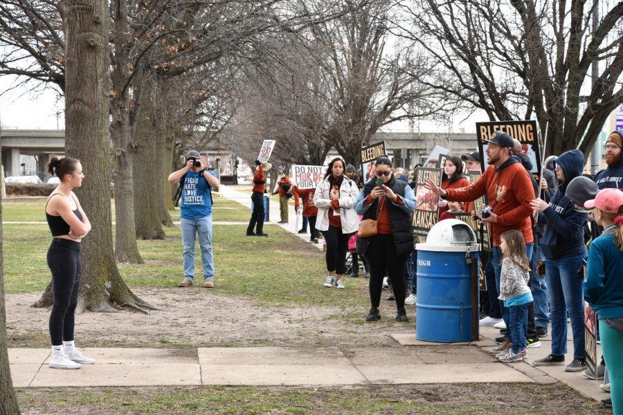 A student from Wichita East High School stands outside th school and speaks to members of Free the States. The student and members argued over the right to abortion on March 2.