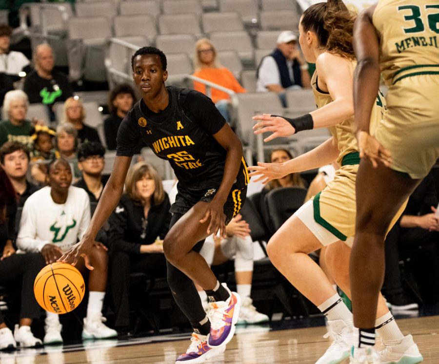 Senior Jane Asinde dribbles the ball during the quarterfinals game vs. South Florida on March 7 at Dickies Arena in Fort Worth. Asinde scored a total of 20 points during Tuesdays game.