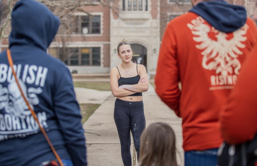 A student from Wichita East High School stands outside the school and speaks to members of Free the States. The student and members argued over the right to abortion on March 2.