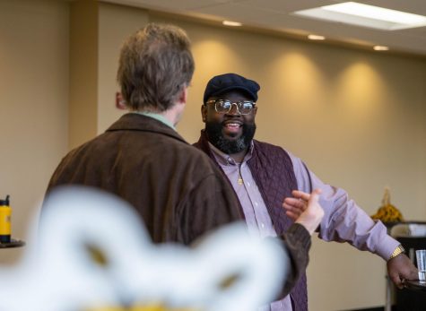 Harold Wallace III speaks with a faculty member during the meet and greet on March 1, 2023.