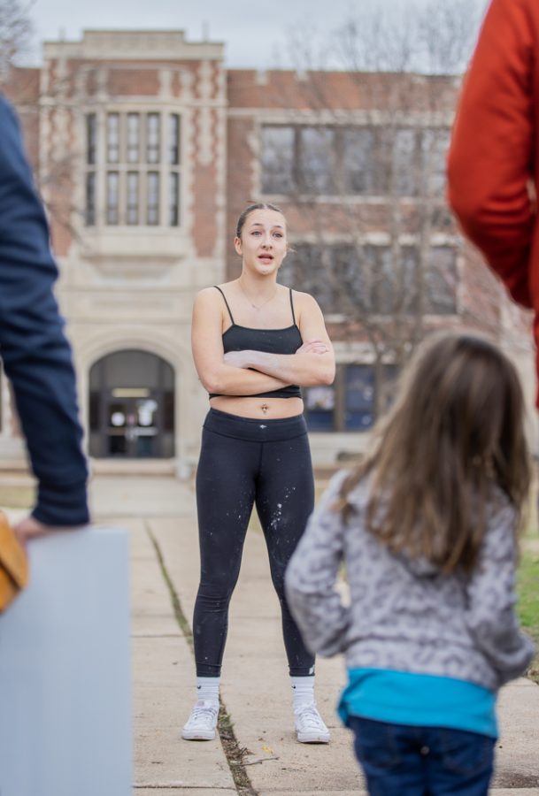 A student from Wichita East High School stands outside the school and speaks to members of Free the States. The student and members argued over the right to abortion on March 2.