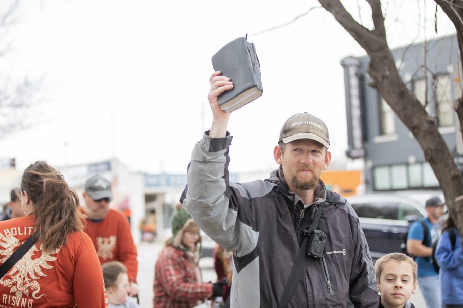 A Free the States member holds up a Bible while marching in protest of abortion in Wichita on March 2.