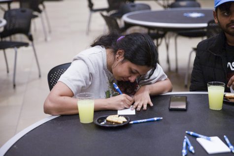 Graduate student Pavithra Santhosh writes a question on an index card. Students could submit questions anonymously to nurse practitioners on the Period Panel on March 2.