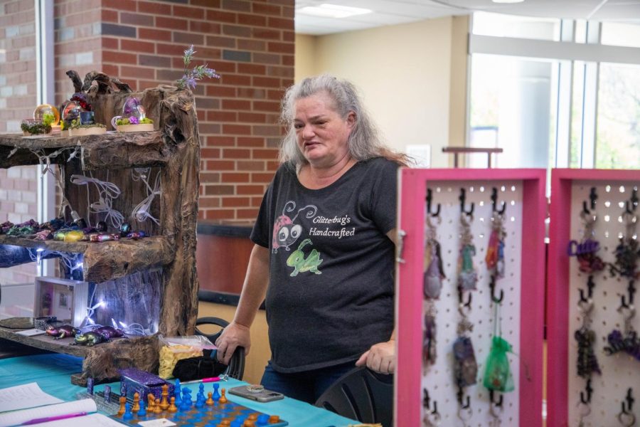 Edna Donohue, owner of Glitterbugs Handcrafted, talks to a passersby about her products. 