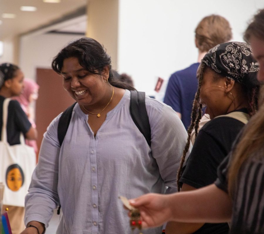 Divya Padanati, a third-year biomedical science major at WSU, laughs at a comment from Emari Shields, a junior studying biomedical science. The pair looked at the Fit For a Queen shop on April 20. 