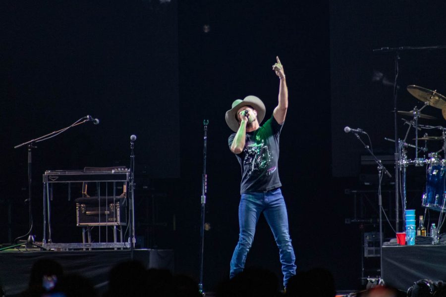 Dustin Lynch points up while signing his opening song Where Its At. The song is the title track of his 2014 album, Lynchs second studio album.