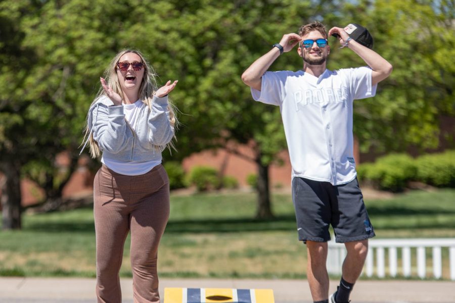 Lauryn Ogden, a senior studying physical education secondary, claps after sinking her bag into the hole scoring three points. Beside Ogden, opponent Daniel Mies removed his hat and grabbed his head in shock. Mies is the Vice President of the PE club and played as part of the Bag Hags team during the April 29 tournament.