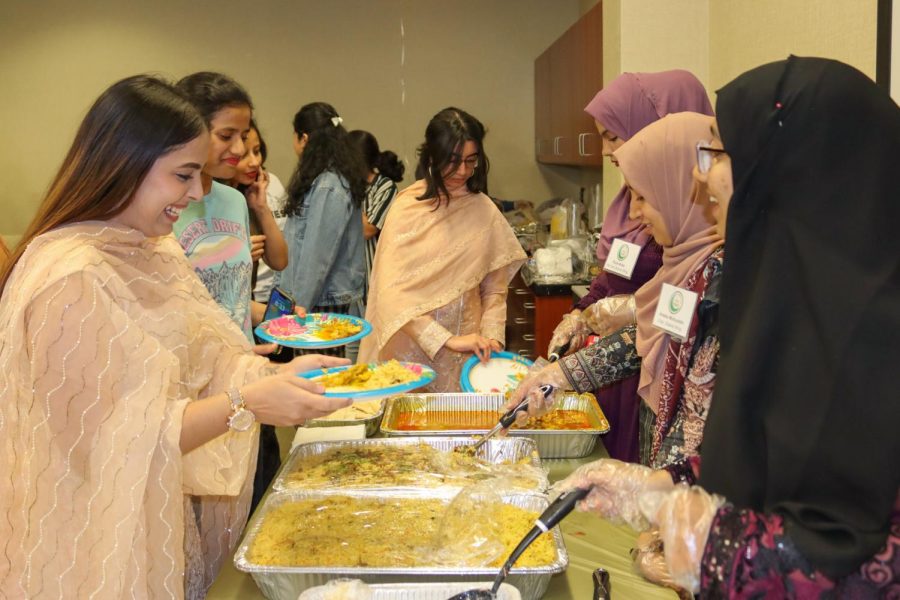 To break their fast, Muslim Students Association members and attendees get food at the Ramadan Iftaar Banquet.