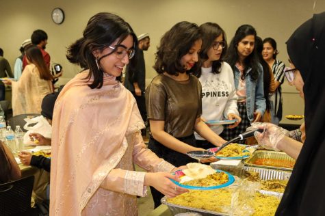 To break their fast, Muslim Students Association members and attendees get food at the Ramadan Iftaar Banquet.