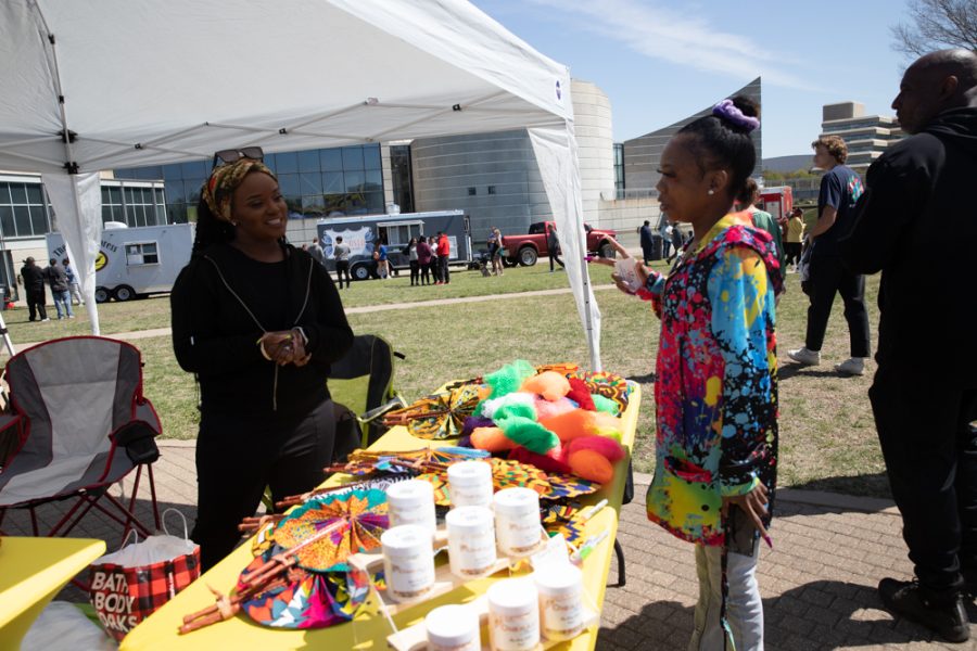 Tiara from Ohemaas Market trades business ideas with another vendor.