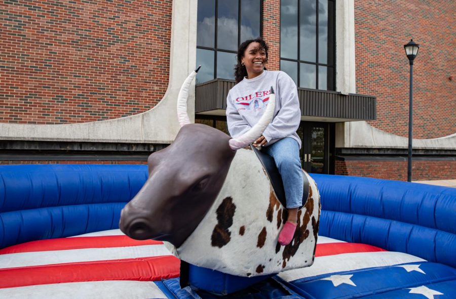 Senor Ayshea Banes rides a mechanical bull at Wichita State on April 21. 