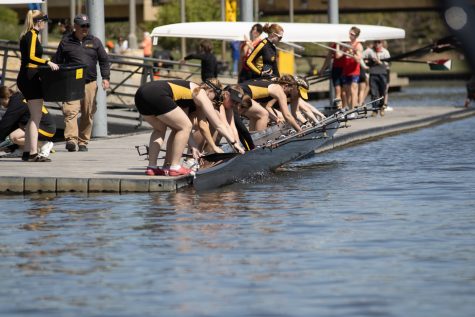 The Wichita State womens rowing team puts their boat in the water during the Plains Regional Regatta on April 23 at Boats and Bikes on River Vista. The womens rowing team placed first in the 3b Womens Novice 8+ Heat 2.