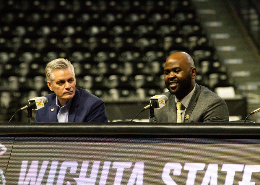 President Richard Muma listens to new head womens basketball coach Terry Nooner at the press conference on April 20 at Charles Koch Arena.