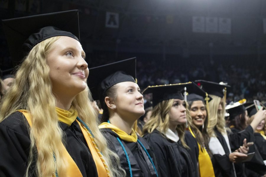 Graduates look for family and friends inside Charles Koch Arena on May 13.