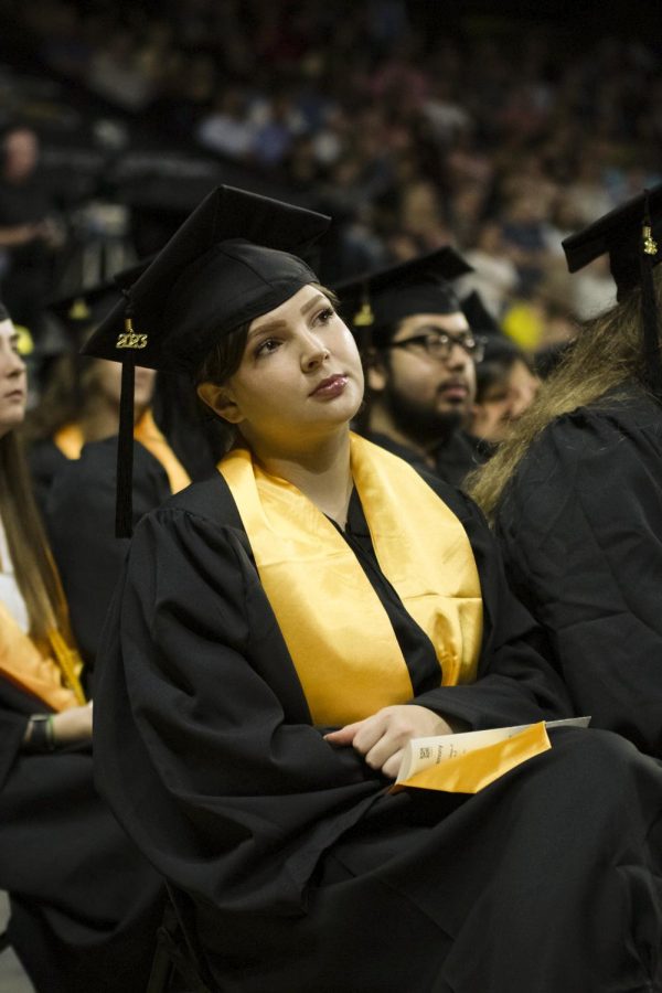 Graduates watch as individuals walk across the stage during the 9 a.m. graduation on May 13.
