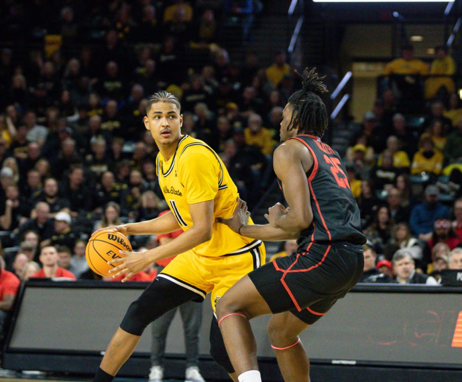 Sophomore Kenny Pohto plays offense against the defenders Houston during the game on Feb. 2 at Charles Koch Arena. 