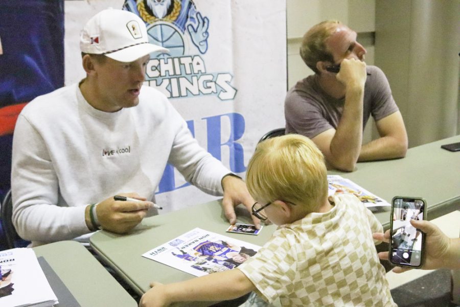 Wichita State alums Ron Baker and Conner Frankamp sign items for fans after the Wichita SkyKings game on May 28. The alums as well as other celebrities were invited for the SkyKings first FanFest.