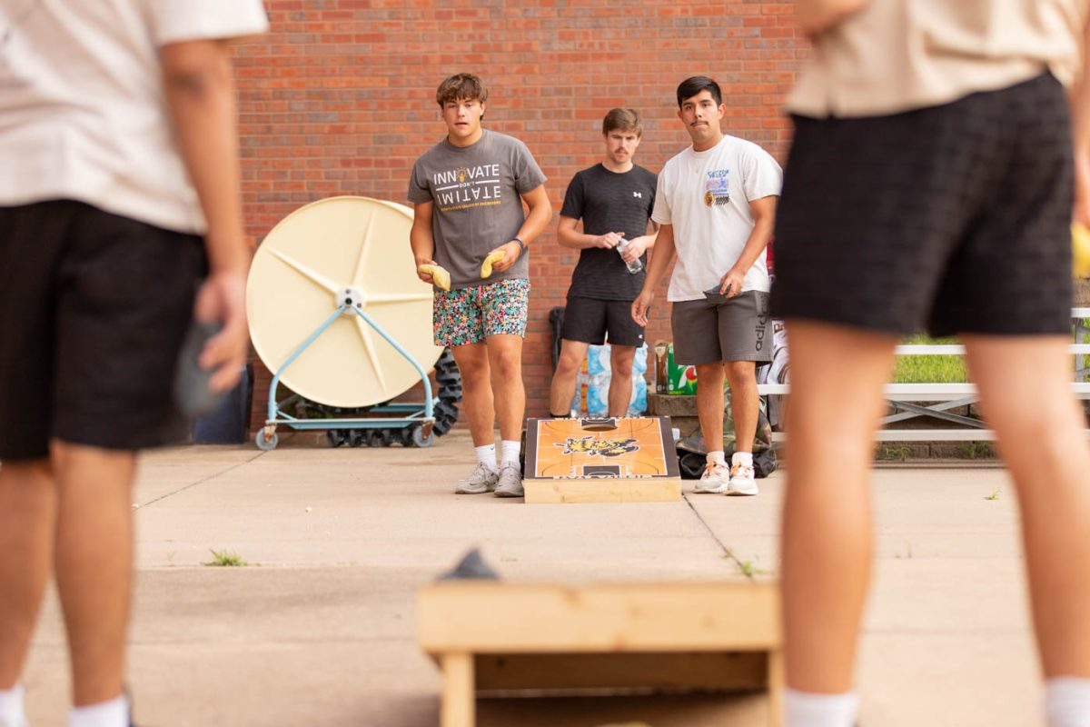 Michael Munter, an incoming freshman studying mechanical engineering, plays a round of cornhole with a few of his peers. 