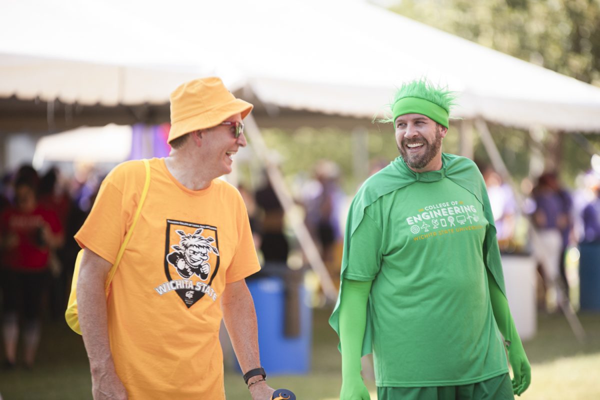 Staff Senate President Jason Bosch (right) laughs at the Class of Colleges event on Aug. 25.