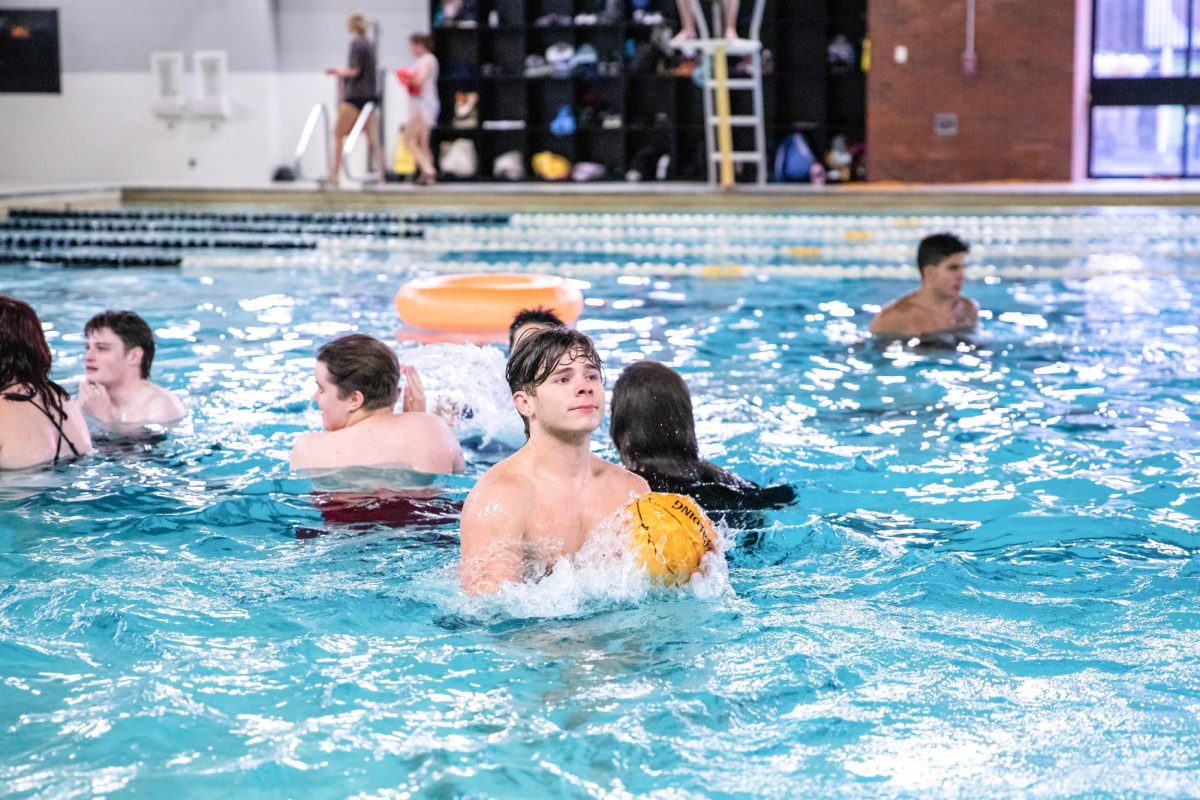 Student plays a match of basketball in the swimming pool of the Heskett Center on Aug. 17. The Pool Party was held by Campus Recreation and Student Housing.
