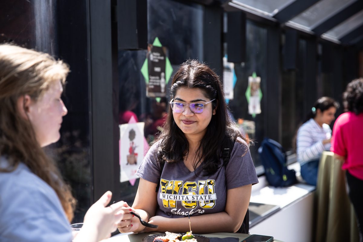 Himanshu relishes her food and talks with friends during the grad schools welcome back celebration on Aug. 18.