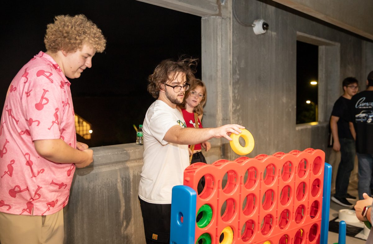 Freshman Jack West playing Connect Four at the garage party. The event was hosted by SAC on Aug. 18. 