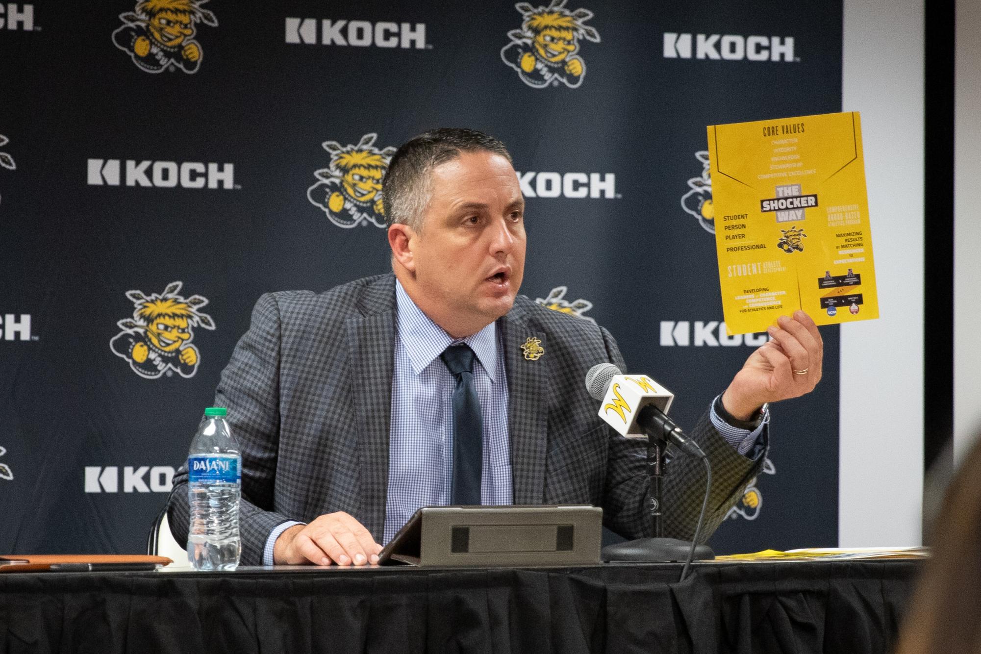 Director of Athletics Kevin Saal shows The Shocker Way document, which the athletics department uses to achieve its mission, at a press confrence on Aug. 15. The Shocker Way outlines three components: core values, student athletic experience, and competitve excellence. 
