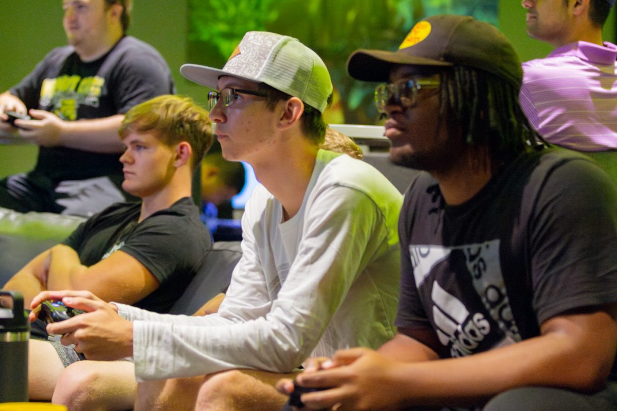Mason Lang and Jareese Miller go head-to-head in a round of Rocket League. The freshmen played on a big screen while many others watch as part of the Esports Hub Open House.