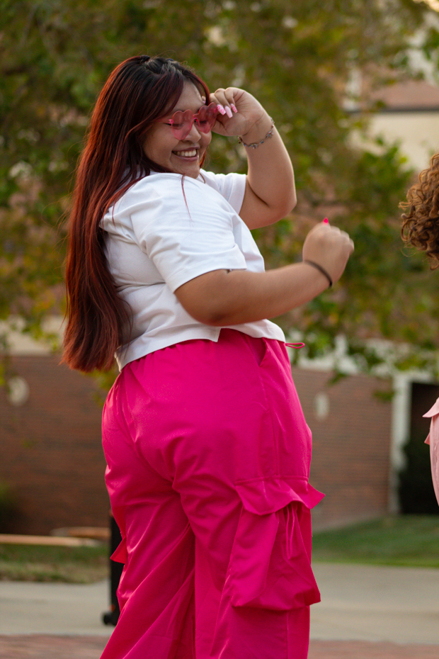 Erika Mendoza smiles as she performs for the crowd. Erika is apart of Kappa Delta Chi.