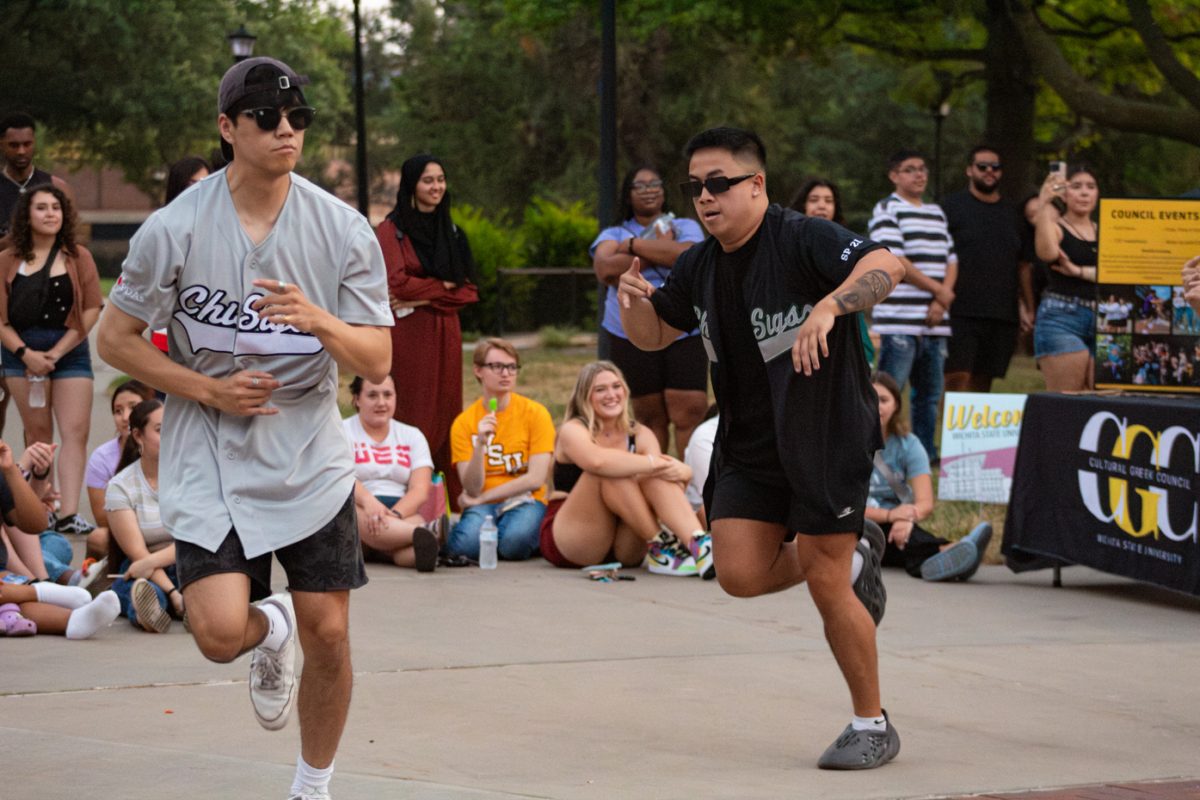 Brain Le and Darren Nguyen stroll together. They are part of Chi Sigma Tau, and performed on Aug. 29 at the Yard Show.