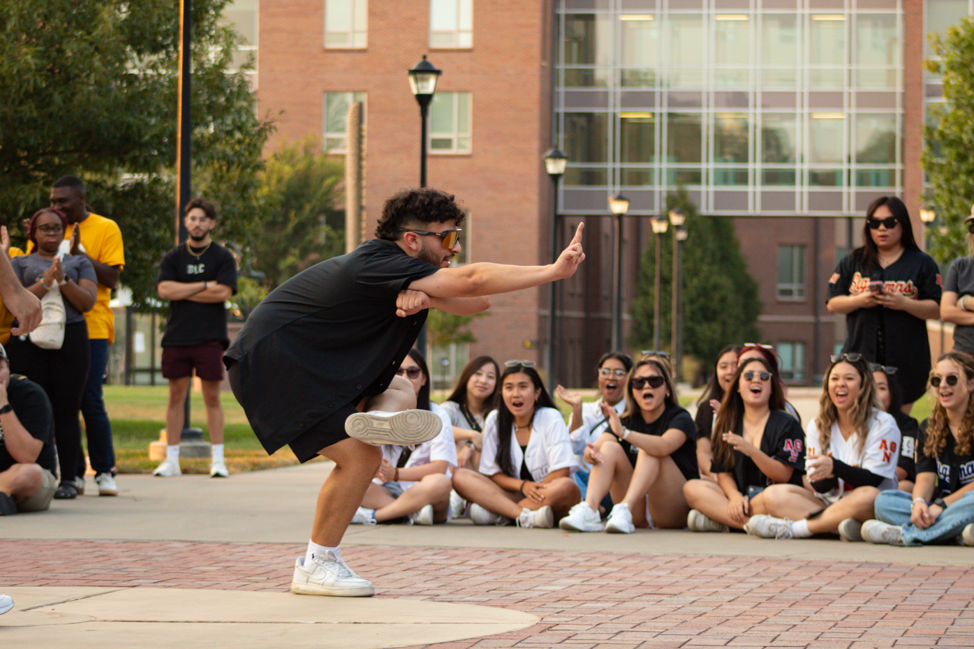 Andres Saenz performs the final move of the dance as the crowd cheers for him. Andres is apart of Sigma Lambda Beta where they performed at the Yard Show on Aug. 29.